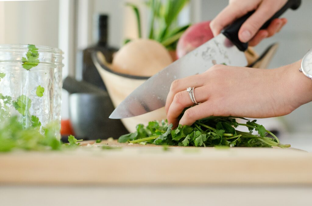 Person chopping vegetables for services, coaching and plant-based January